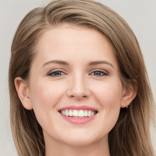 Joyful white young-adult female with long  brown hair and grey eyes