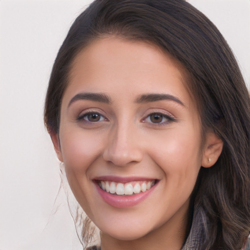 Joyful white young-adult female with long  brown hair and brown eyes