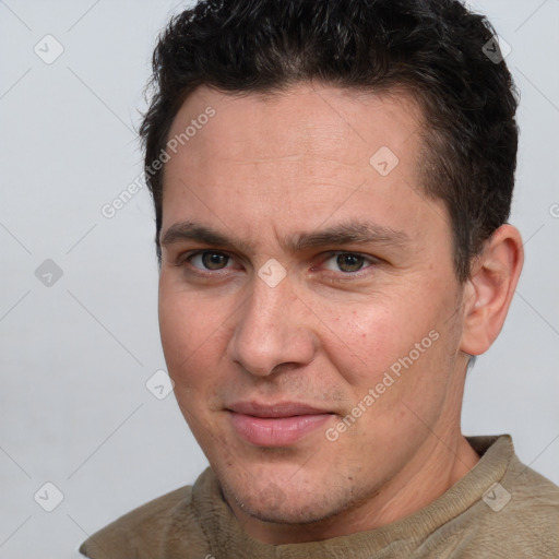 Joyful white adult male with short  brown hair and brown eyes