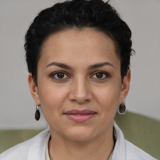 Joyful latino young-adult female with short  brown hair and brown eyes