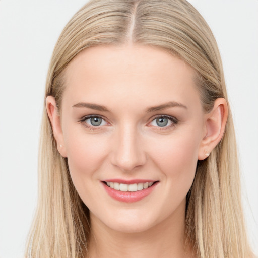 Joyful white young-adult female with long  brown hair and blue eyes