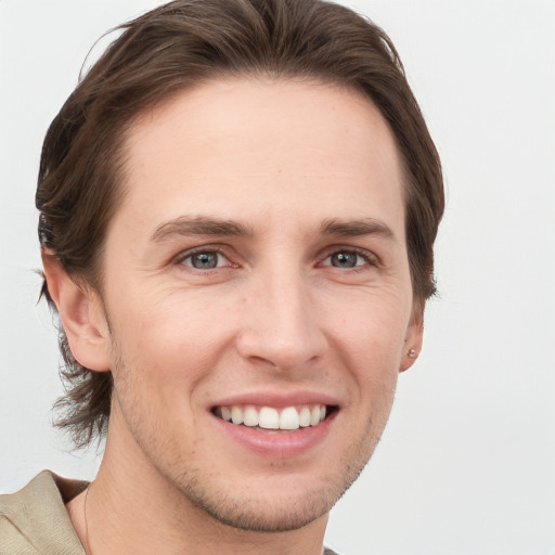 Joyful white young-adult male with short  brown hair and grey eyes