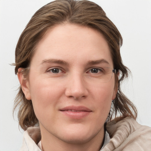 Joyful white young-adult female with medium  brown hair and blue eyes