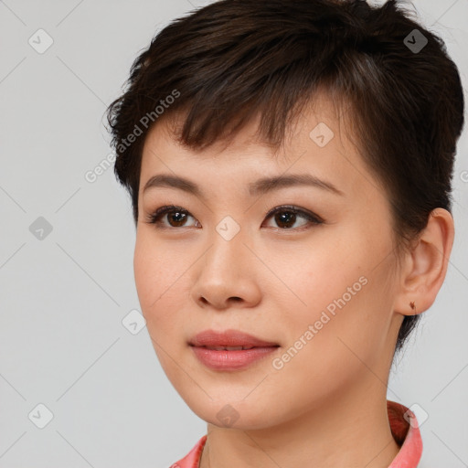 Joyful asian young-adult female with short  brown hair and brown eyes