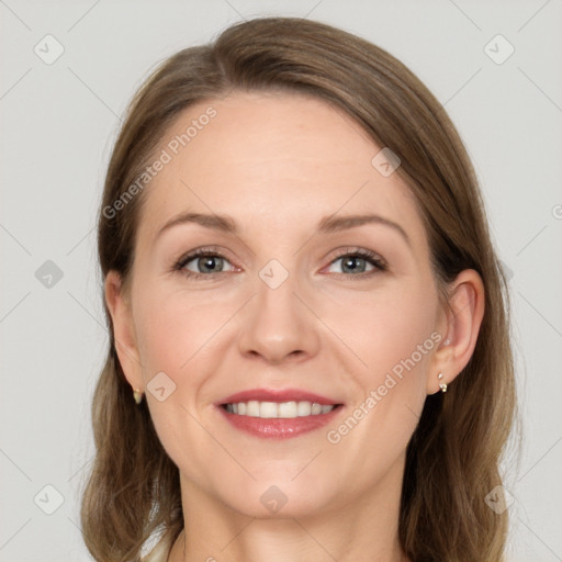 Joyful white adult female with long  brown hair and grey eyes