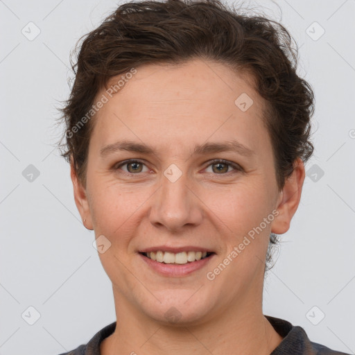 Joyful white adult female with short  brown hair and grey eyes