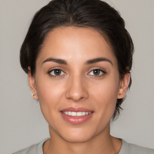 Joyful white young-adult female with medium  brown hair and brown eyes