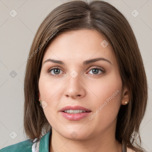 Joyful white young-adult female with medium  brown hair and grey eyes