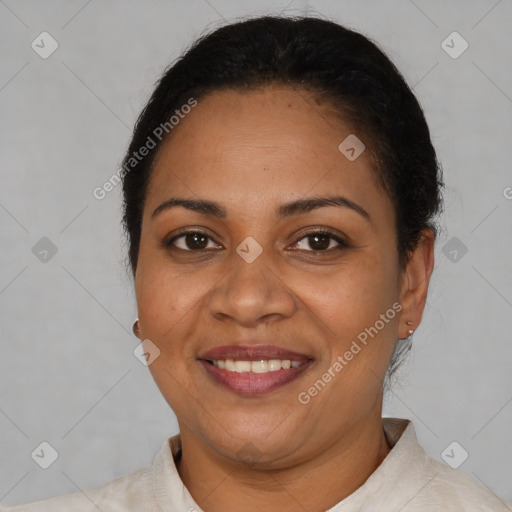 Joyful latino adult female with short  brown hair and brown eyes