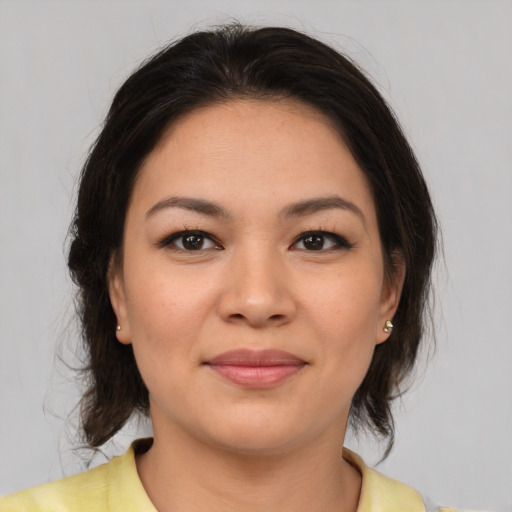 Joyful asian young-adult female with medium  brown hair and brown eyes