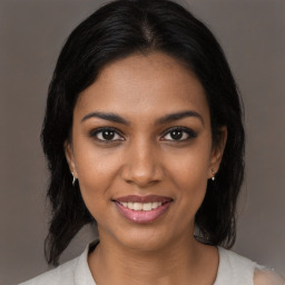 Joyful black young-adult female with medium  brown hair and brown eyes