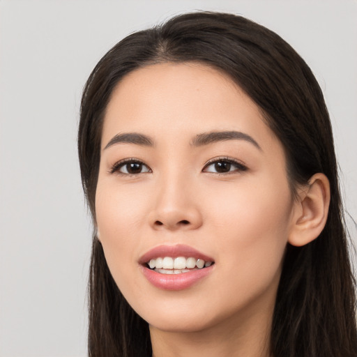 Joyful white young-adult female with long  black hair and brown eyes