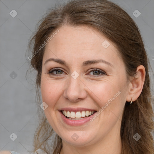 Joyful white adult female with long  brown hair and brown eyes