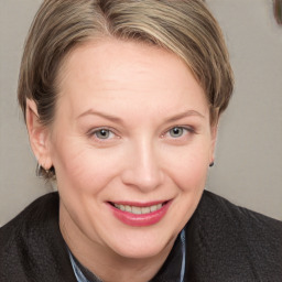 Joyful white adult female with medium  brown hair and blue eyes