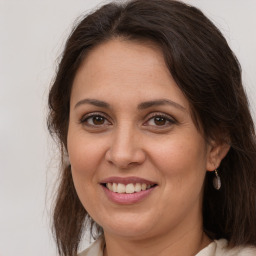 Joyful white adult female with medium  brown hair and brown eyes