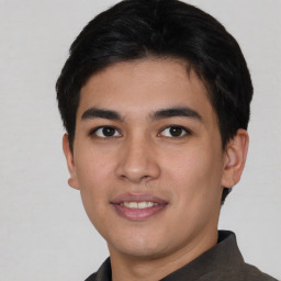 Joyful asian young-adult male with short  brown hair and brown eyes