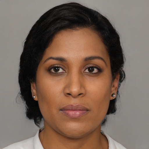 Joyful black young-adult female with medium  black hair and brown eyes