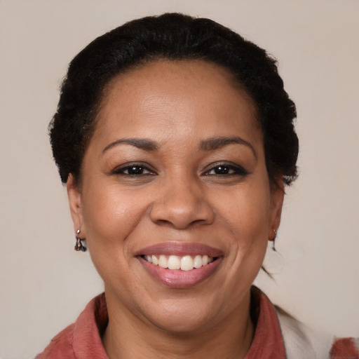 Joyful black adult female with medium  brown hair and brown eyes