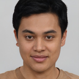 Joyful asian young-adult male with short  brown hair and brown eyes