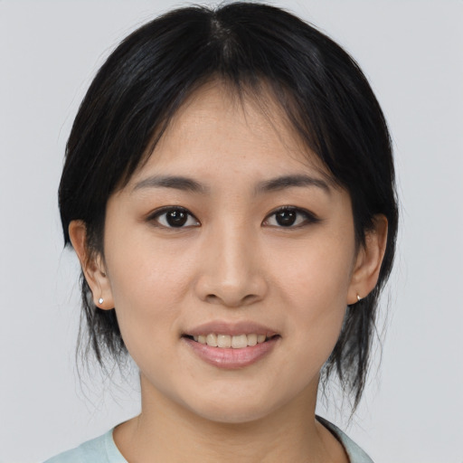 Joyful asian young-adult female with medium  brown hair and brown eyes