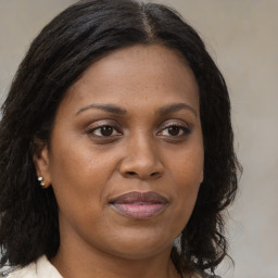 Joyful black young-adult female with medium  brown hair and brown eyes