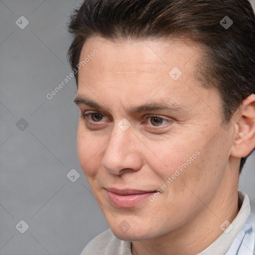 Joyful white adult male with short  brown hair and brown eyes