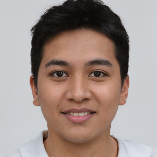 Joyful asian young-adult male with short  brown hair and brown eyes