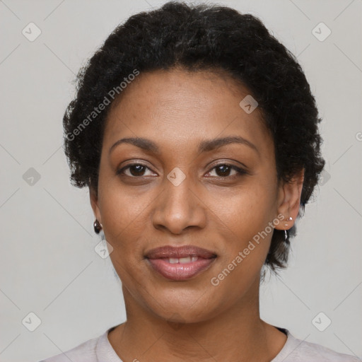 Joyful black adult female with short  black hair and brown eyes