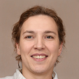 Joyful white adult female with medium  brown hair and brown eyes