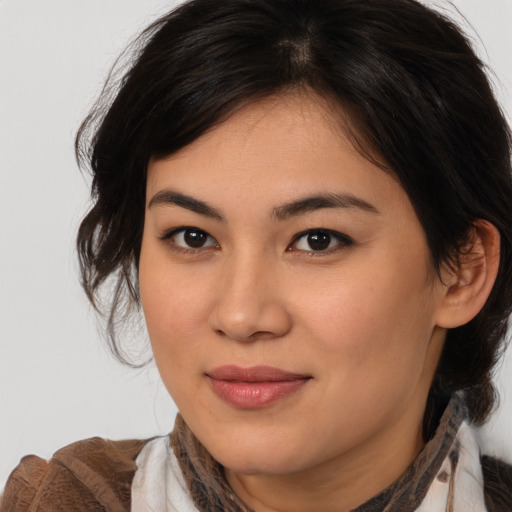 Joyful asian young-adult female with medium  brown hair and brown eyes