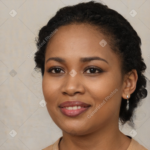 Joyful black young-adult female with long  black hair and brown eyes