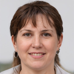 Joyful white adult female with medium  brown hair and grey eyes