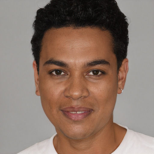 Joyful black young-adult male with short  black hair and brown eyes