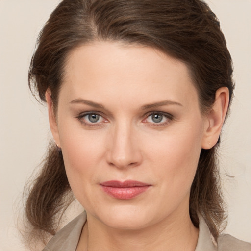 Joyful white young-adult female with medium  brown hair and brown eyes