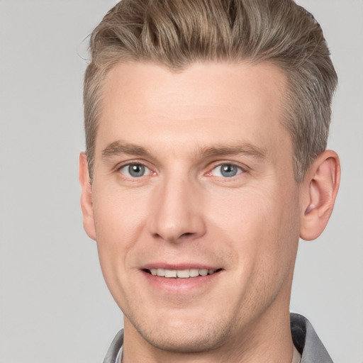 Joyful white adult male with short  brown hair and grey eyes