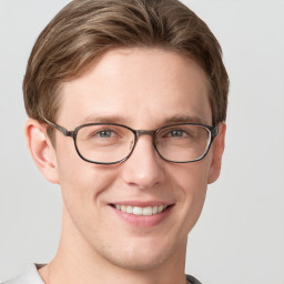 Joyful white young-adult male with short  brown hair and grey eyes