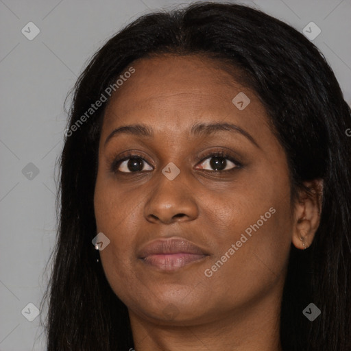 Joyful black adult female with long  brown hair and brown eyes