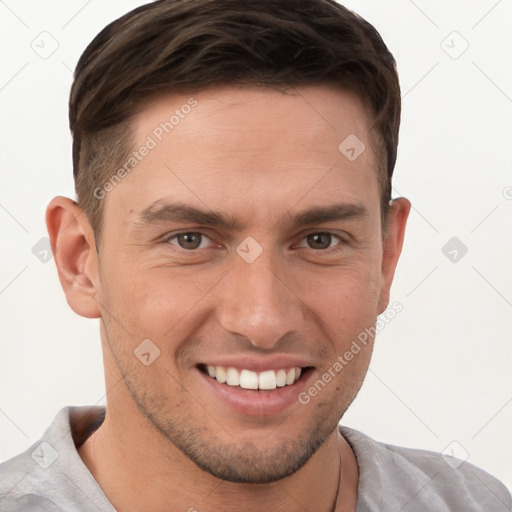 Joyful white young-adult male with short  brown hair and grey eyes