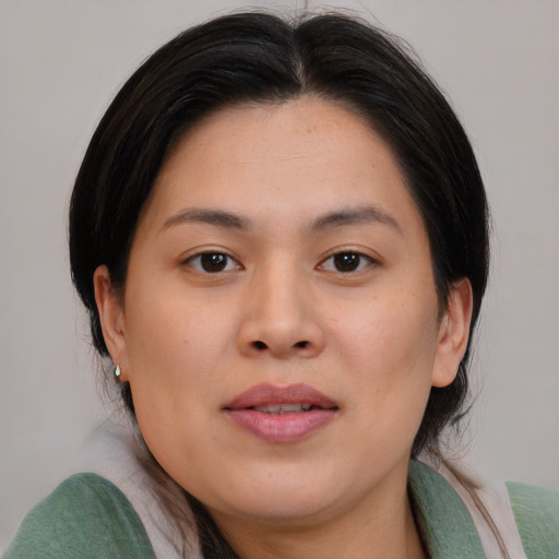 Joyful asian young-adult female with medium  brown hair and brown eyes