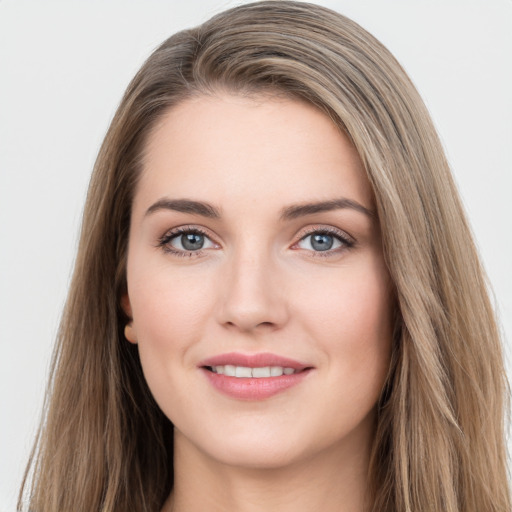 Joyful white young-adult female with long  brown hair and grey eyes