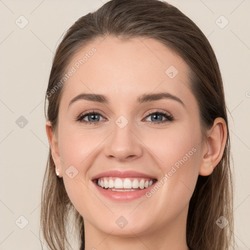 Joyful white young-adult female with long  brown hair and grey eyes