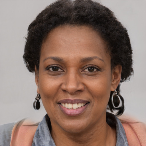 Joyful black adult female with short  brown hair and brown eyes