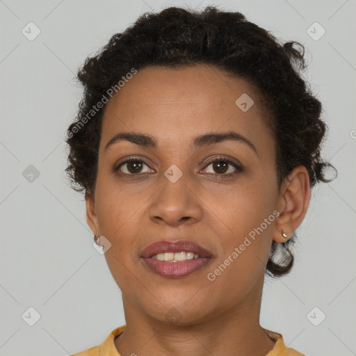 Joyful black adult female with short  brown hair and brown eyes