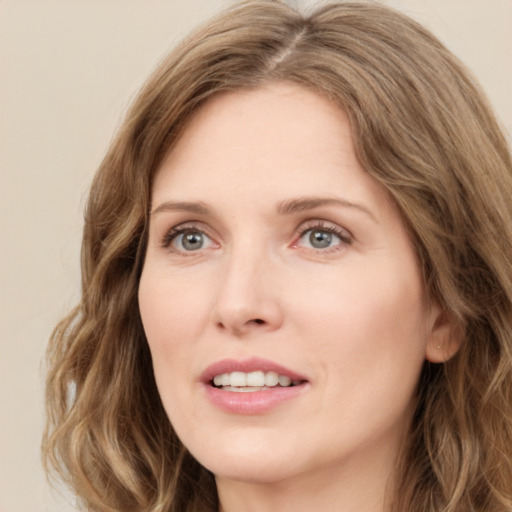 Joyful white young-adult female with long  brown hair and green eyes