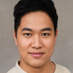 Joyful asian young-adult male with short  black hair and brown eyes