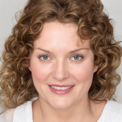 Joyful white young-adult female with medium  brown hair and blue eyes