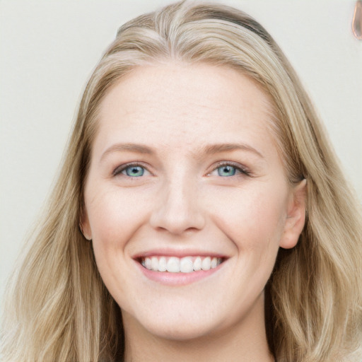 Joyful white young-adult female with long  brown hair and blue eyes