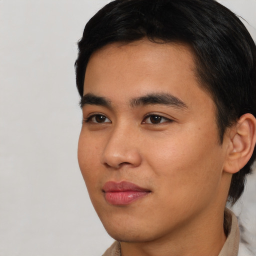 Joyful asian young-adult male with short  black hair and brown eyes