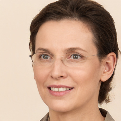 Joyful white adult female with medium  brown hair and brown eyes