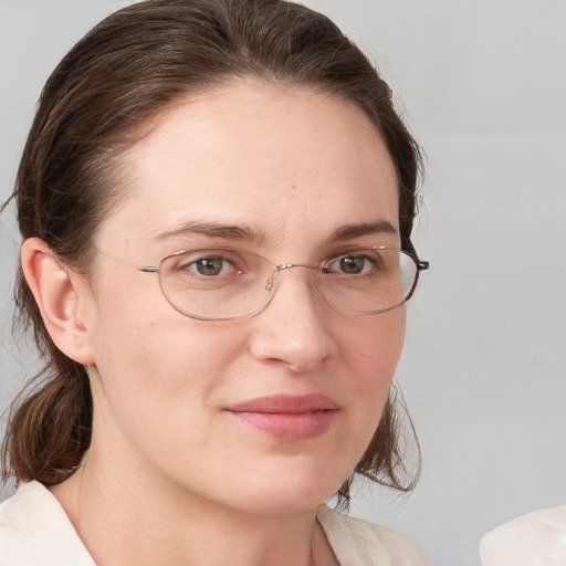 Joyful white adult female with medium  brown hair and grey eyes